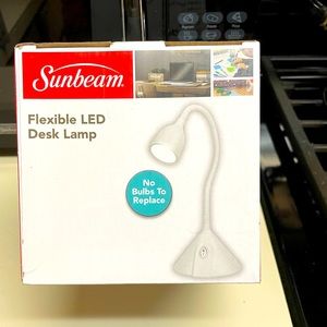 Sunbeam flex LED desk lamp comes in two colors black and white.  New in the box.